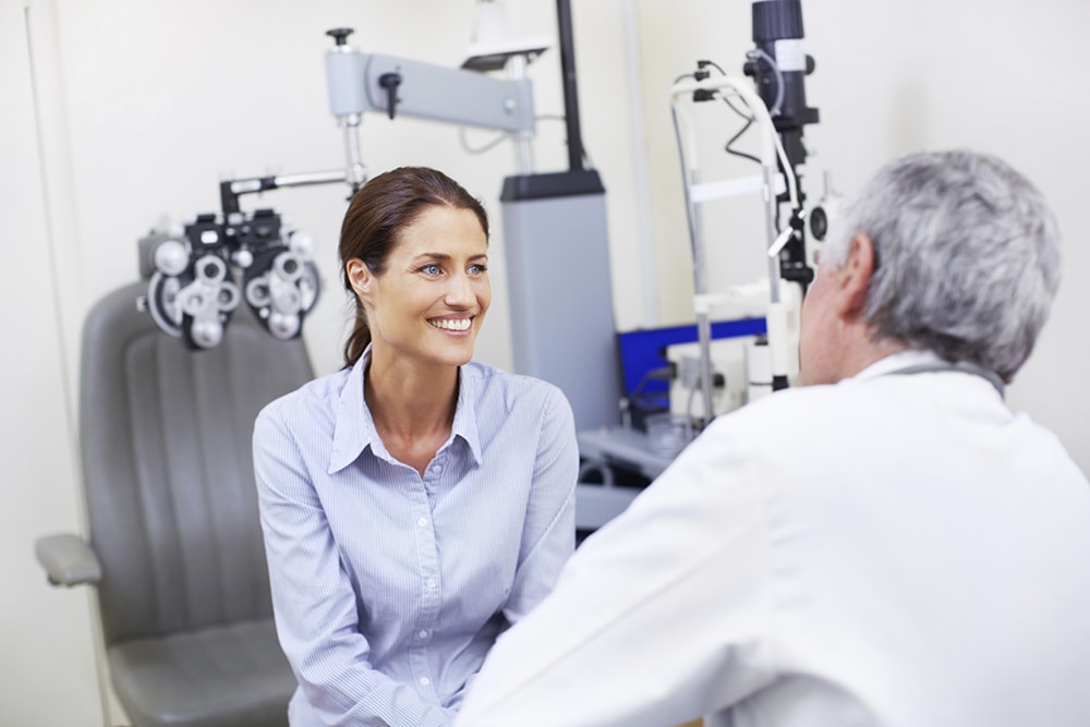 An ophthalmologist talking through the informed consent with a patient 