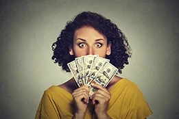 Surprised woman fanning out money