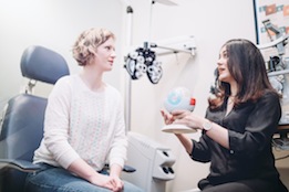 Female Optometrist Performs Eye Exam