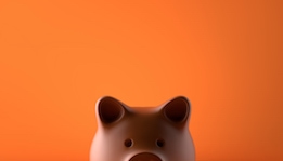 Piggy bank in front of orange background